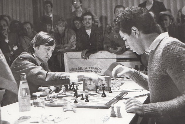 Russian chess grandmasters Boris Spassky, right, and Anatoly Karpov, left,  shake hands the news